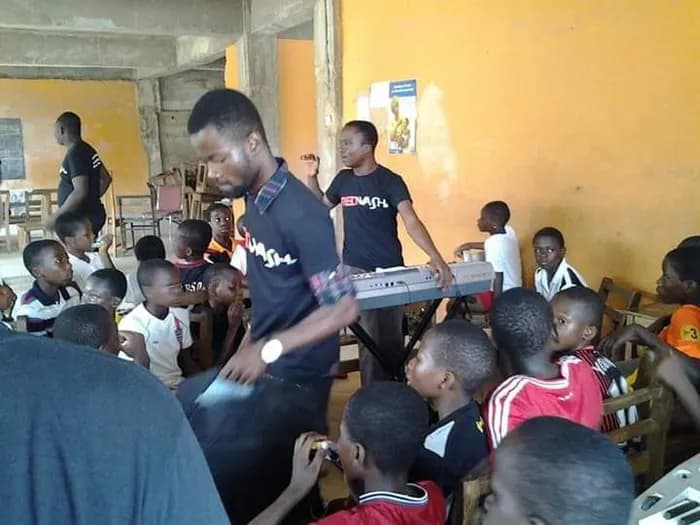 A child reaches in to find the notes · Accra