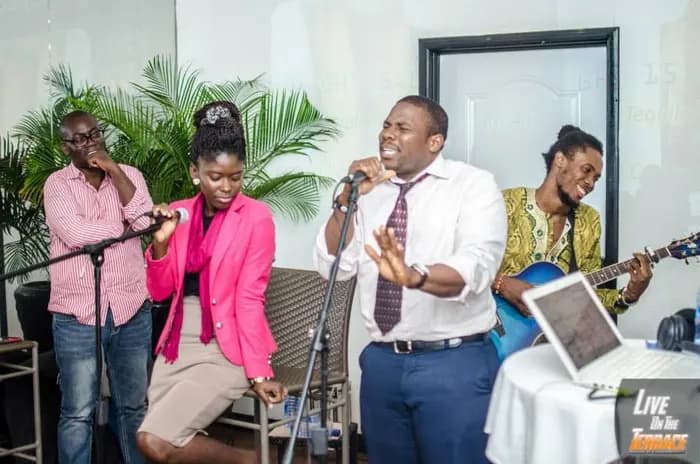A Red Friday set — live band, mics, an audience · Accra