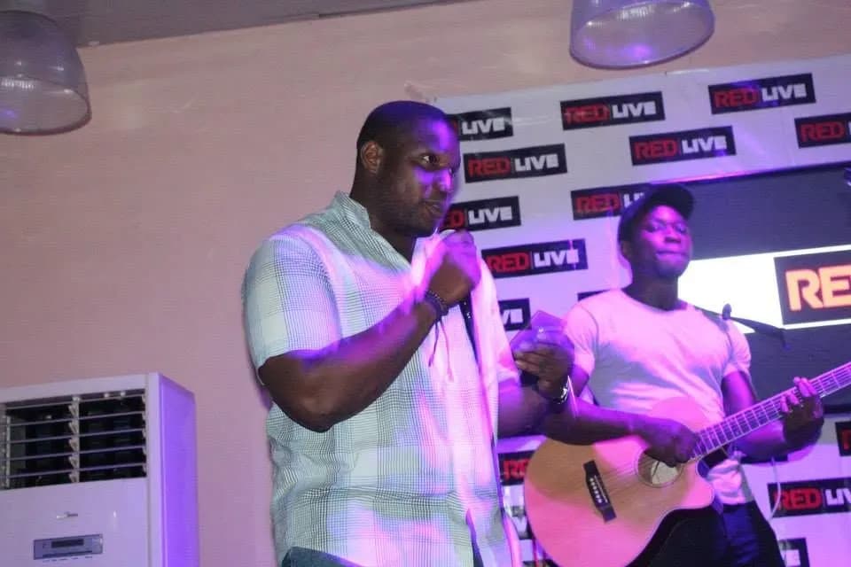 A singer, and a guitarist behind him · Accra
