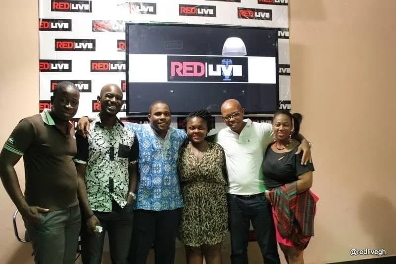Guests and crew in front of the REDLIVE screen · Accra