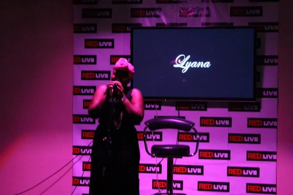 A singer silhouetted against the screen · Accra