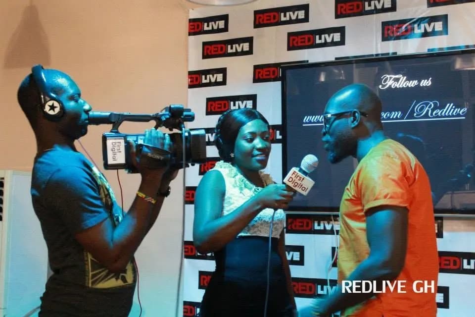 Filming an interview against the backdrop · Accra