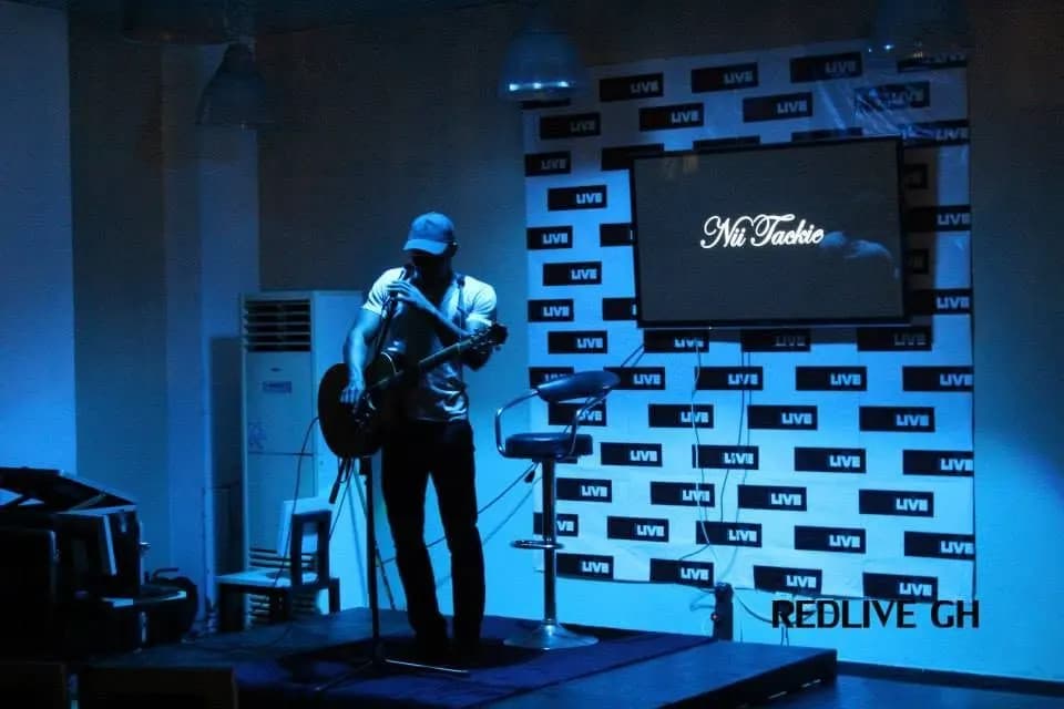 Alone on stage under the lights · Accra